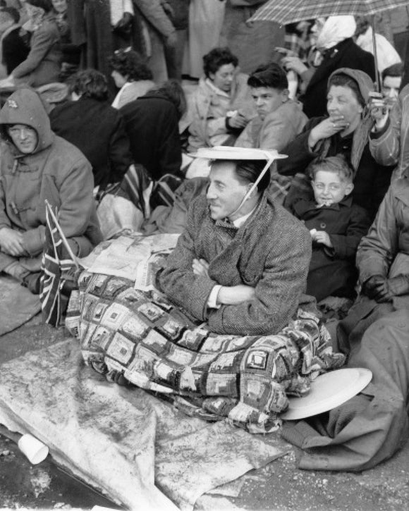 Spectators waiting on the pavement for Queen Elizabeth II's Coronation: 1953