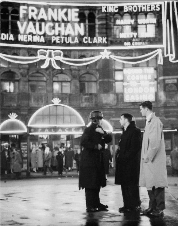 A group of men talking outside the Palace Theatre, Shaftsbury Avenue: c. 1955