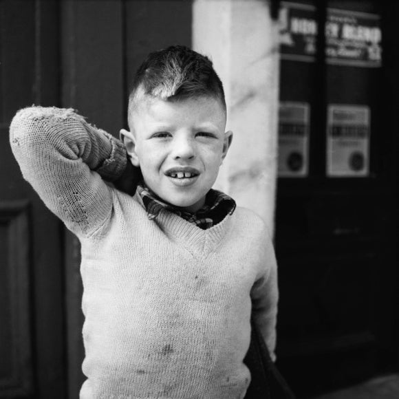 Portrait of a young boy in an Islington street; 1956