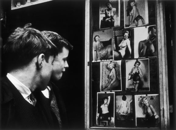 Two boys gazing at images of semi-nude women: 1961