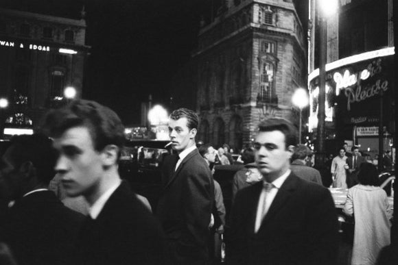 Passers-by on a London street at night c.1955